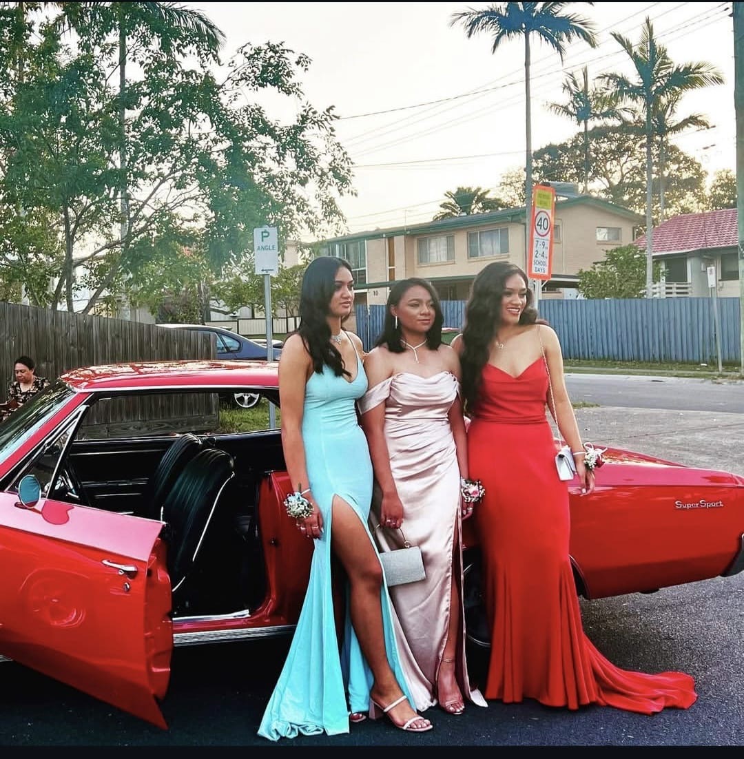 Three girls in formal gowns with the Chevelle