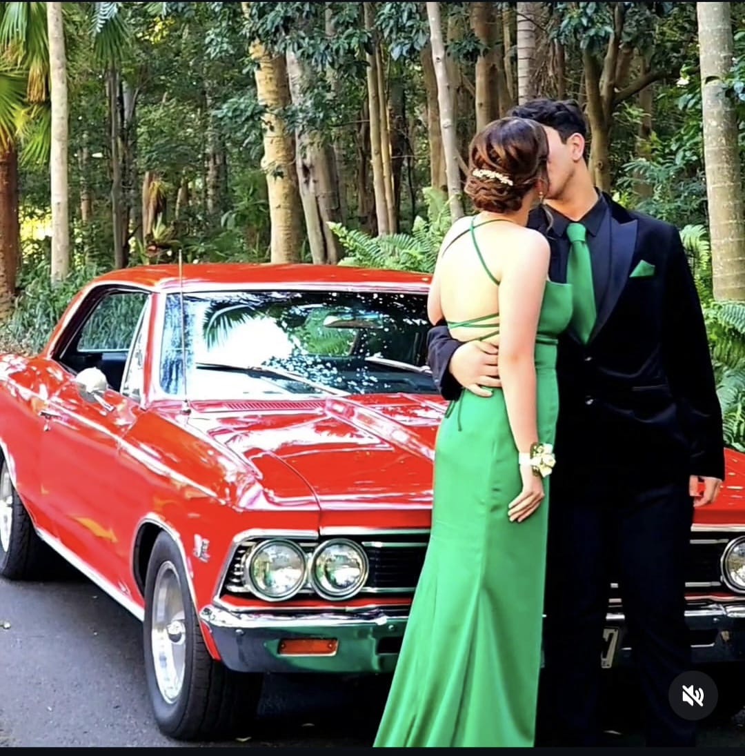 Couple in formal wear beside the Chevelle